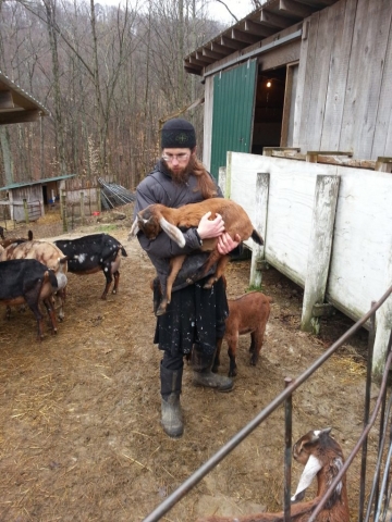 Monk Michael caring for the goats - their milk is used in soap-making