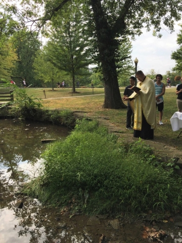 Father blesses the water which flows through campus