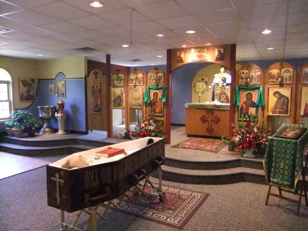The body of Archpriest Peter E. Gillquist lying in state at All Saints' Orthodox Church, Bloomington, Indiana, the day before his burial. By User:Vmenkov - Own work, CC BY-SA 3.0, https://commons.wikimedia.org/w/index.php?curid=20159659